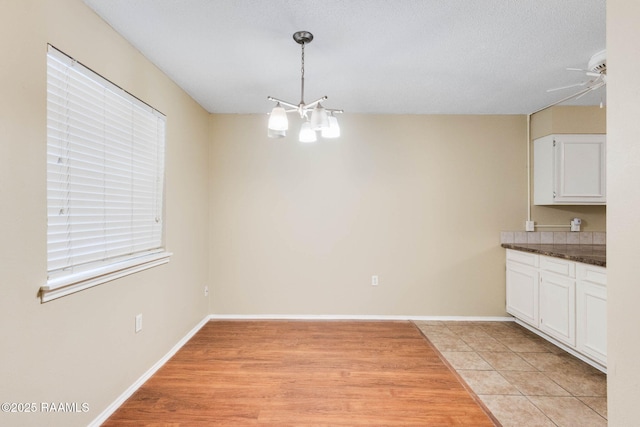 1314 Dulles Dr Unit F, Lafayette, LA 70506 - unfurnished dining area featuring a ceiling fan, baseboards, and light tile patterned floors