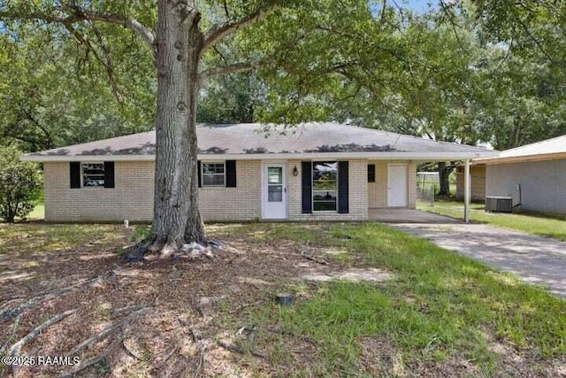 650 Juanita St, Eunice, LA 70535 - single story home with brick siding, an attached carport, driveway, and central AC unit