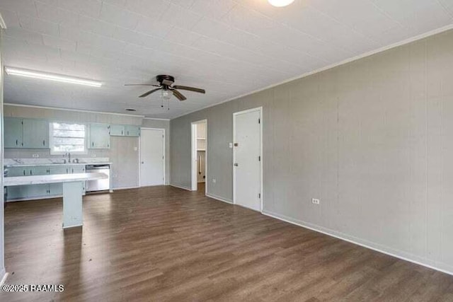 650 Juanita St, Eunice, LA 70535 - unfurnished living room featuring ceiling fan, dark wood-style floors, a sink, and baseboards