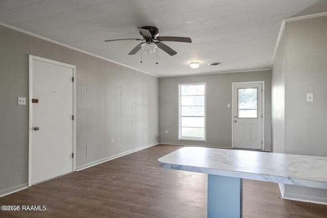 650 Juanita St, Eunice, LA 70535 - entryway with ornamental molding, dark wood-style flooring, a ceiling fan, and baseboards