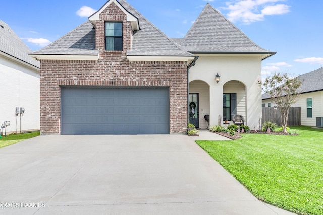 103 Misty Wind Dr, Broussard, LA 70518 - french country style house with a front lawn, a shingled roof, an attached garage, and concrete driveway