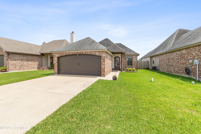 710 Highland View Dr, Youngsville, LA 70592 - french provincial home featuring a garage, a front lawn, brick siding, concrete driveway, and central AC
