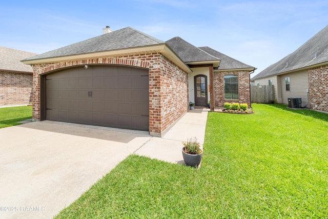 710 Highland View Dr, Youngsville, LA 70592 - french country home with brick siding, a shingled roof, cooling unit, a front yard, and a garage