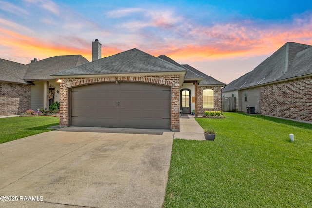 710 Highland View Dr, Youngsville, LA 70592 - french provincial home featuring brick siding, an attached garage, driveway, and a lawn