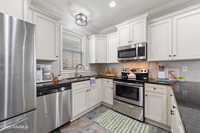 710 Highland View Dr, Youngsville, LA 70592 - kitchen featuring stainless steel appliances, a sink, dark stone finish floors, ornamental molding, and white cabinetry