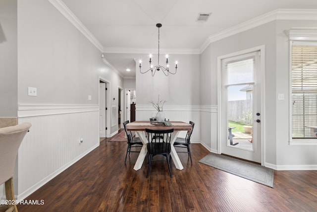 710 Highland View Dr, Youngsville, LA 70592 - dining room featuring dark wood-style flooring, a wainscoted wall, a chandelier, and ornamental molding