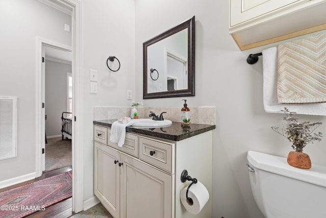 710 Highland View Dr, Youngsville, LA 70592 - bathroom with toilet, vanity, and baseboards
