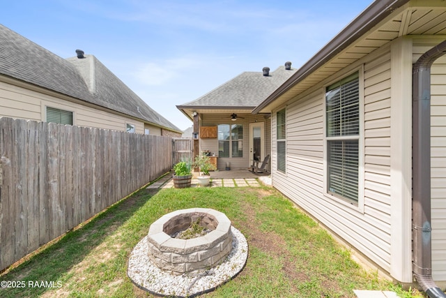 710 Highland View Dr, Youngsville, LA 70592 - view of yard featuring ceiling fan, a fire pit, and a patio
