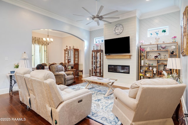 106 Camry Dr, Lafayette, LA 70503 - living area with arched walkways, a fireplace, dark wood-style floors, a ceiling fan, and a chandelier