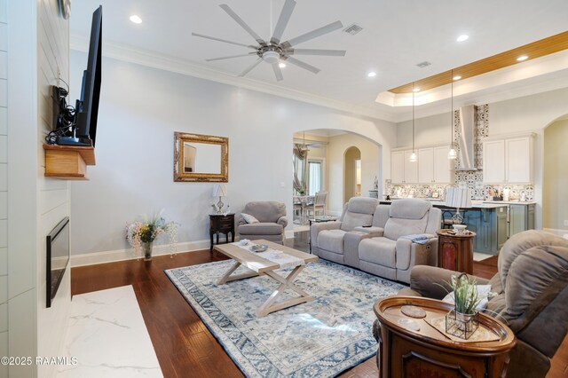 106 Camry Dr, Lafayette, LA 70503 - living area featuring arched walkways, ceiling fan, recessed lighting, ornamental molding, and dark wood finished floors