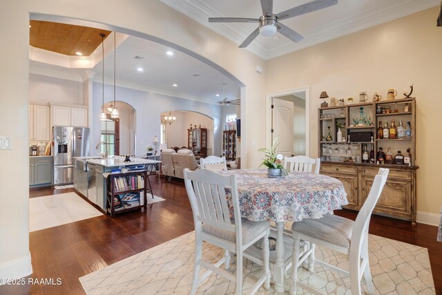 106 Camry Dr, Lafayette, LA 70503 - dining space featuring ceiling fan, arched walkways, dark wood-style floors, a chandelier, and ornamental molding