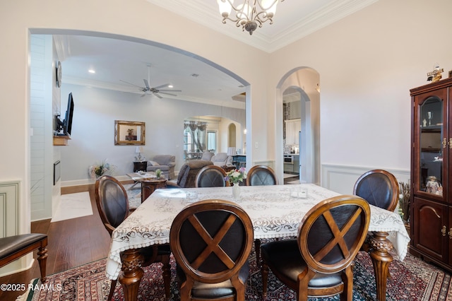 106 Camry Dr, Lafayette, LA 70503 - dining area with arched walkways, ornamental molding, a ceiling fan, wood finished floors, and a chandelier