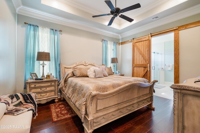 106 Camry Dr, Lafayette, LA 70503 - bedroom with dark wood-style floors, ornamental molding, a raised ceiling, a barn door, and ensuite bath