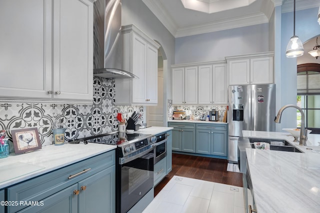 106 Camry Dr, Lafayette, LA 70503 - kitchen with wall chimney exhaust hood, stainless steel appliances, a sink, white cabinetry, and blue cabinets