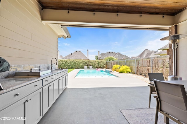 105 Hazy River Way, Lafayette, LA 70508 - view of pool featuring exterior kitchen, a sink, a fenced backyard, and a patio