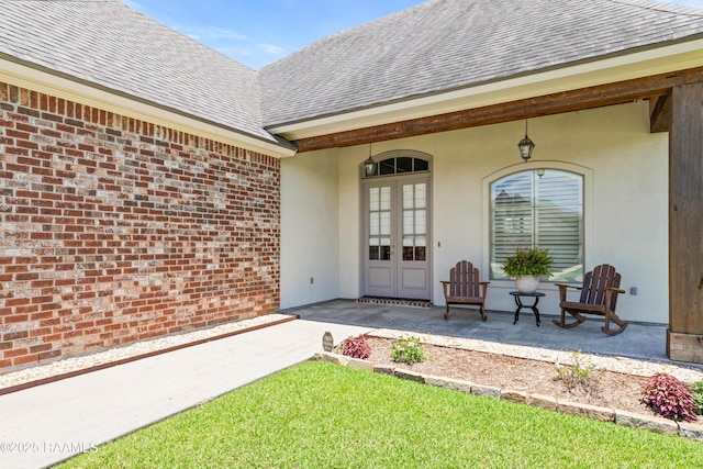 105 Hazy River Way, Lafayette, LA 70508 - property entrance with roof with shingles, french doors, brick siding, and stucco siding