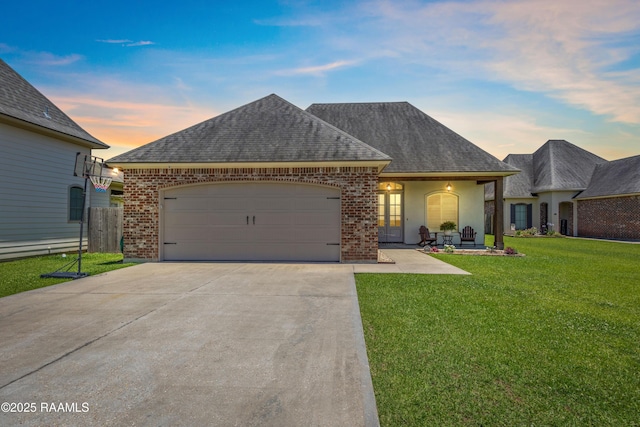 105 Hazy River Way, Lafayette, LA 70508 - french country inspired facade featuring roof with shingles, driveway, brick siding, and an attached garage