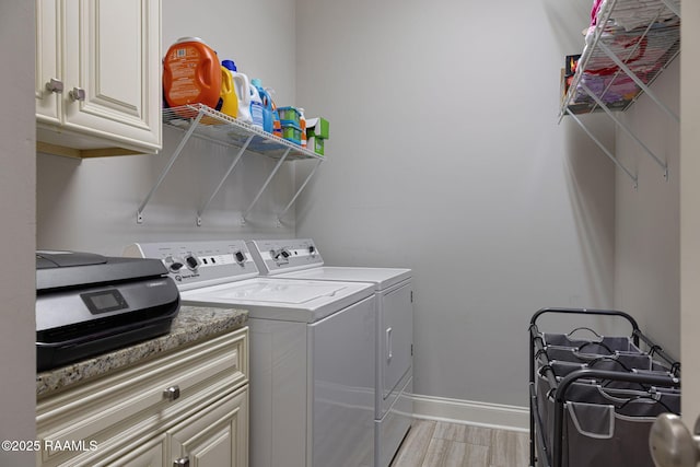105 Hazy River Way, Lafayette, LA 70508 - laundry room with separate washer and dryer, cabinet space, light wood-style flooring, and baseboards
