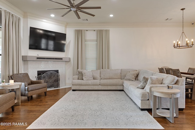 105 Hazy River Way, Lafayette, LA 70508 - living area featuring a chandelier, ceiling fan, dark wood-style flooring, crown molding, and a fireplace