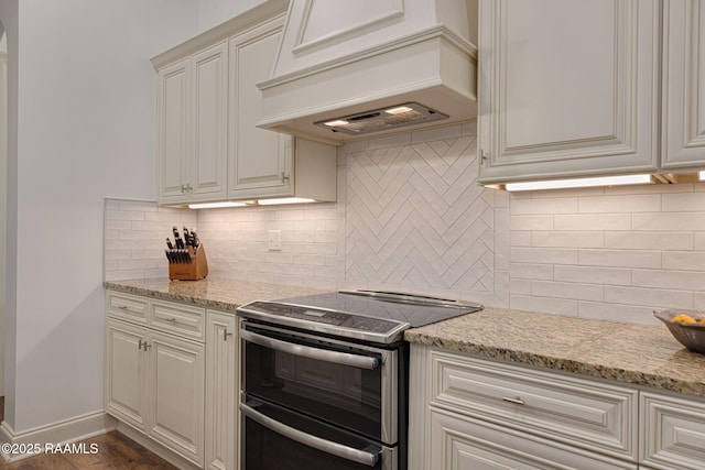 105 Hazy River Way, Lafayette, LA 70508 - kitchen with double oven range, decorative backsplash, custom range hood, and light stone countertops