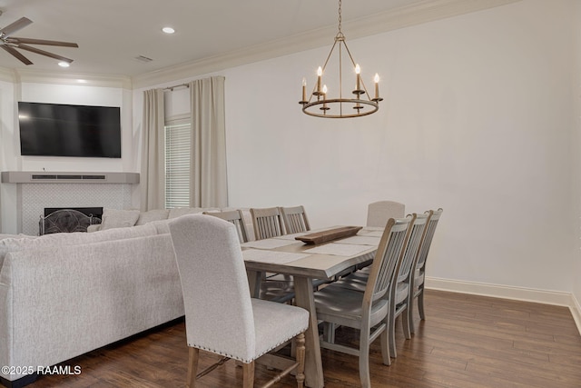 105 Hazy River Way, Lafayette, LA 70508 - dining room with a chandelier, crown molding, a ceiling fan, dark wood-style flooring, and a tile fireplace