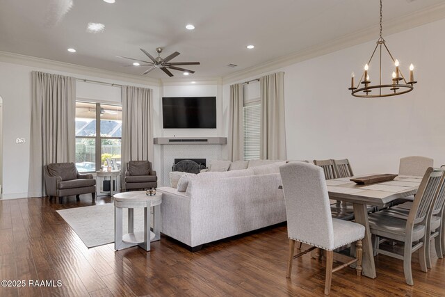 105 Hazy River Way, Lafayette, LA 70508 - living room featuring ornamental molding, a tile fireplace, a chandelier, a ceiling fan, and dark wood finished floors