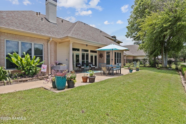102 Capilano Ln, Broussard, LA 70518 - back of property featuring brick siding, a shingled roof, a patio, and a chimney