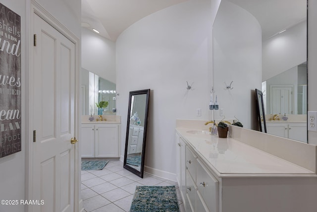 102 Capilano Ln, Broussard, LA 70518 - full bath with two vanities, vaulted ceiling, and tile patterned flooring