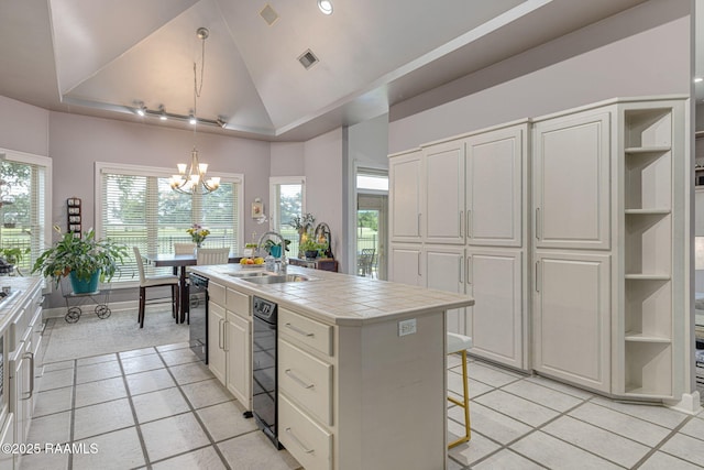 102 Capilano Ln, Broussard, LA 70518 - kitchen with tile counters, open shelves, a chandelier, lofted ceiling, and dishwasher