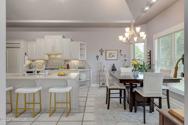 102 Capilano Ln, Broussard, LA 70518 - dining room featuring a chandelier, lofted ceiling, and light tile patterned floors