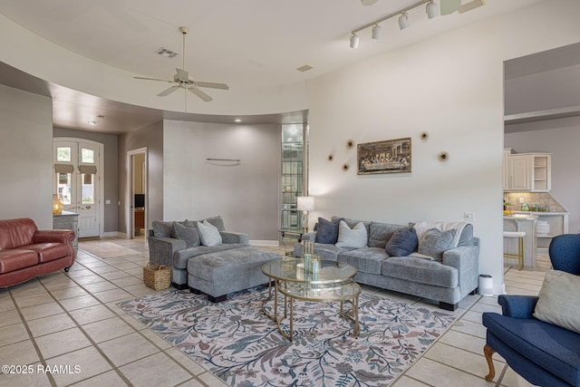 102 Capilano Ln, Broussard, LA 70518 - living room featuring a ceiling fan, light tile patterned flooring, and track lighting