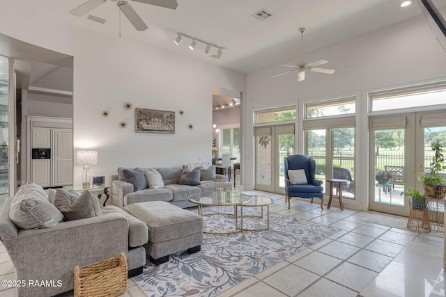 102 Capilano Ln, Broussard, LA 70518 - living room featuring ceiling fan, a high ceiling, plenty of natural light, and track lighting