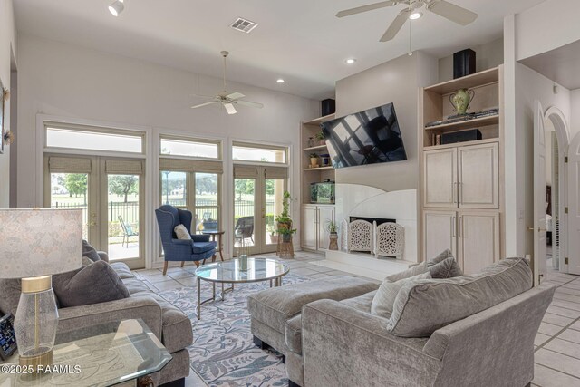 102 Capilano Ln, Broussard, LA 70518 - living room with ceiling fan, light tile patterned floors, built in shelves, recessed lighting, and french doors