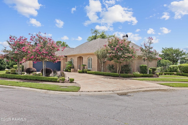 102 Capilano Ln, Broussard, LA 70518 - view of front of house featuring concrete driveway, a garage, and a chimney