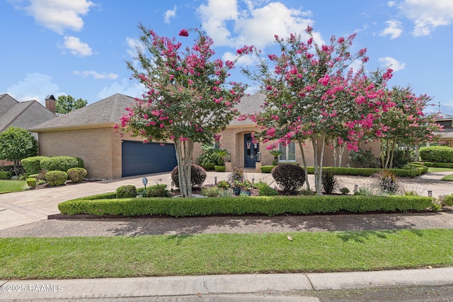 102 Capilano Ln, Broussard, LA 70518 - view of front of property featuring a garage, brick siding, curved driveway, and a chimney