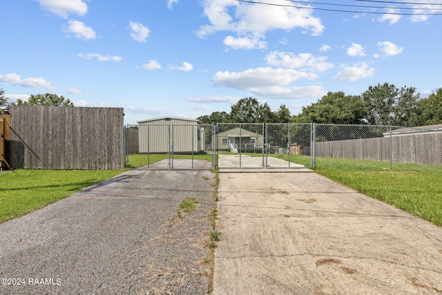 311 Grossie Dr, Lafayette, LA 70501 - view of asphalt driveway featuring a gate and a gated entry