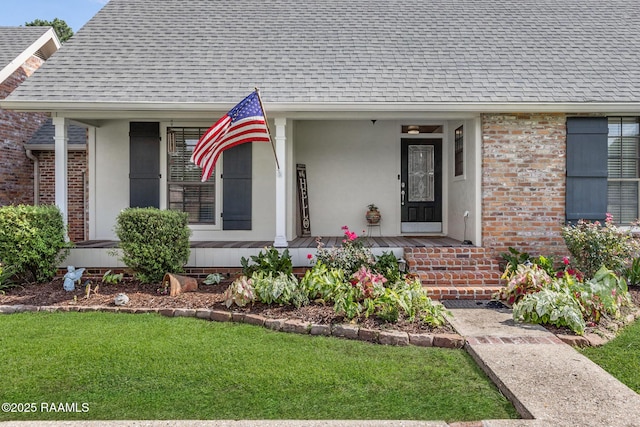 1714 Christopher Fox Ln, New Iberia, LA 70563 - doorway to property featuring a shingled roof, brick siding, a yard, and covered porch