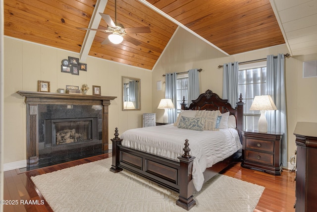 1714 Christopher Fox Ln, New Iberia, LA 70563 - bedroom featuring wood ceiling, vaulted ceiling, wood finished floors, a premium fireplace, and baseboards