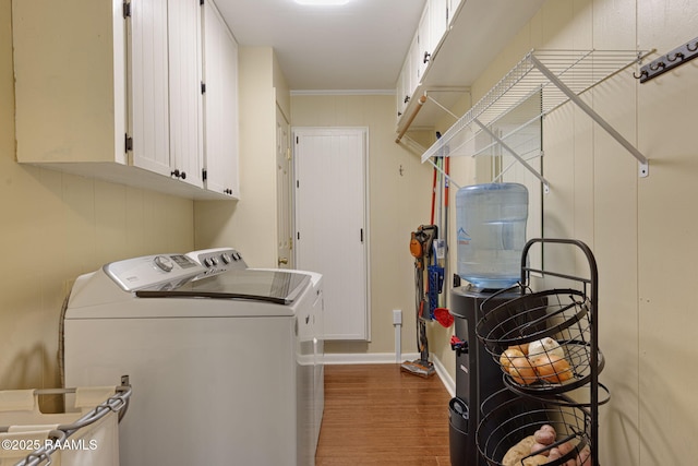 1714 Christopher Fox Ln, New Iberia, LA 70563 - laundry area with washing machine and dryer, cabinet space, wood finished floors, baseboards, and crown molding
