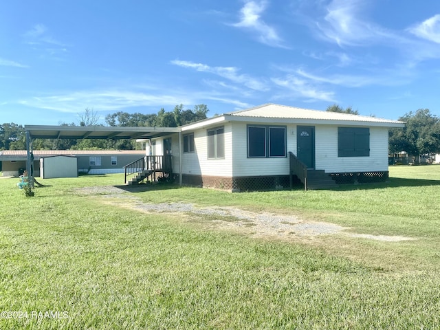 1034 Barras Rd, Saint Martinville, LA 70582 - view of home's exterior featuring entry steps, a yard, and metal roof