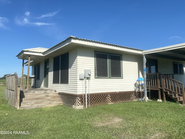 1034 Barras Rd, Saint Martinville, LA 70582 - view of side of property with a lawn and metal roof