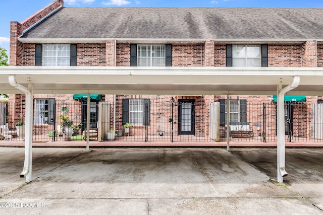 111 Jo Mar Rd, Lafayette, LA 70508 - view of front facade with brick siding, roof with shingles, and covered parking