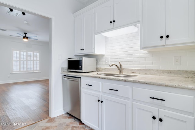 111 Jo Mar Rd, Lafayette, LA 70508 - kitchen featuring stainless steel dishwasher, a sink, white microwave, backsplash, and ceiling fan