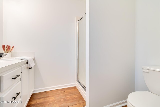 111 Jo Mar Rd, Lafayette, LA 70508 - full bathroom featuring toilet, a shower stall, wood finished floors, and vanity