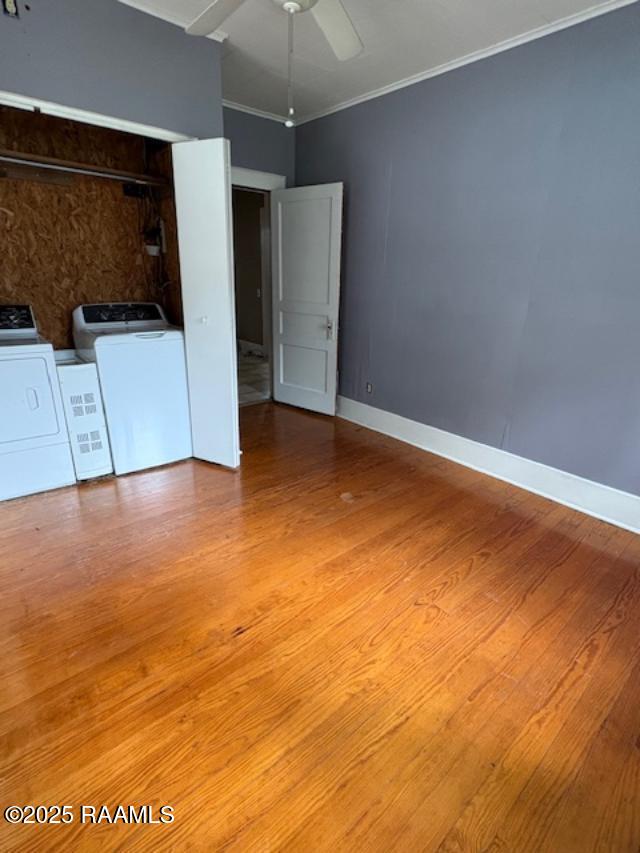 700 S State St, Abbeville, LA 70510 - spare room with washer and clothes dryer, ornamental molding, wood finished floors, baseboards, and ceiling fan