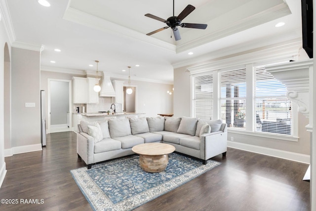 111 San Sebastian Dr, Youngsville, LA 70592 - living area with a tray ceiling, dark wood finished floors, ceiling fan, recessed lighting, and ornamental molding
