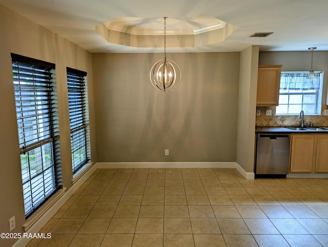 103 E Weeks Dr, Youngsville, LA 70592 - unfurnished dining area featuring a sink, a tray ceiling, light tile patterned flooring, baseboards, and a chandelier