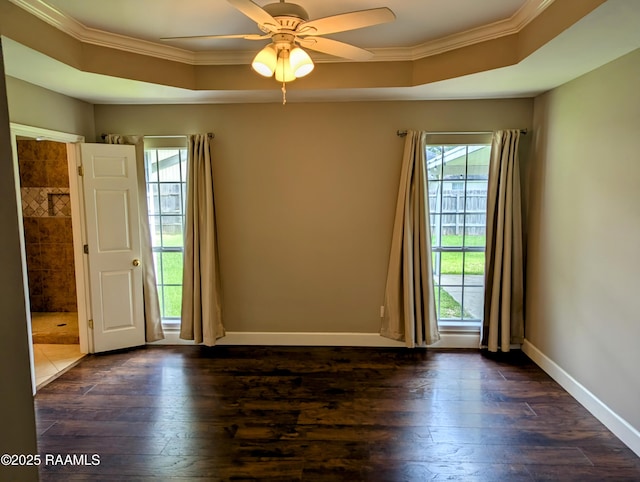 103 E Weeks Dr, Youngsville, LA 70592 - spare room featuring ornamental molding, plenty of natural light, dark wood-style flooring, and a tray ceiling