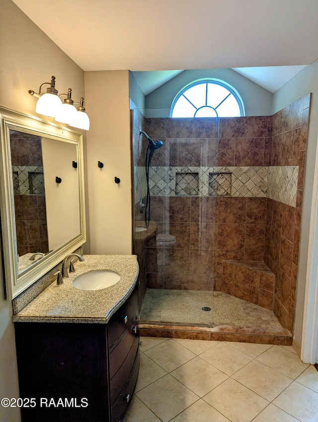 103 E Weeks Dr, Youngsville, LA 70592 - full bath with vanity, a tile shower, tile patterned flooring, and vaulted ceiling
