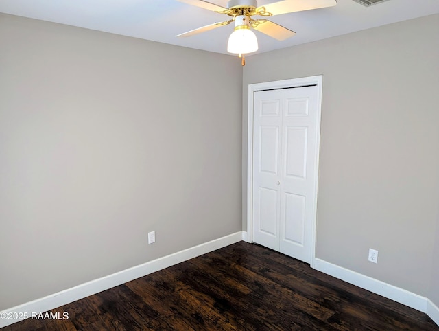 103 E Weeks Dr, Youngsville, LA 70592 - spare room with baseboards, dark wood-style flooring, and a ceiling fan